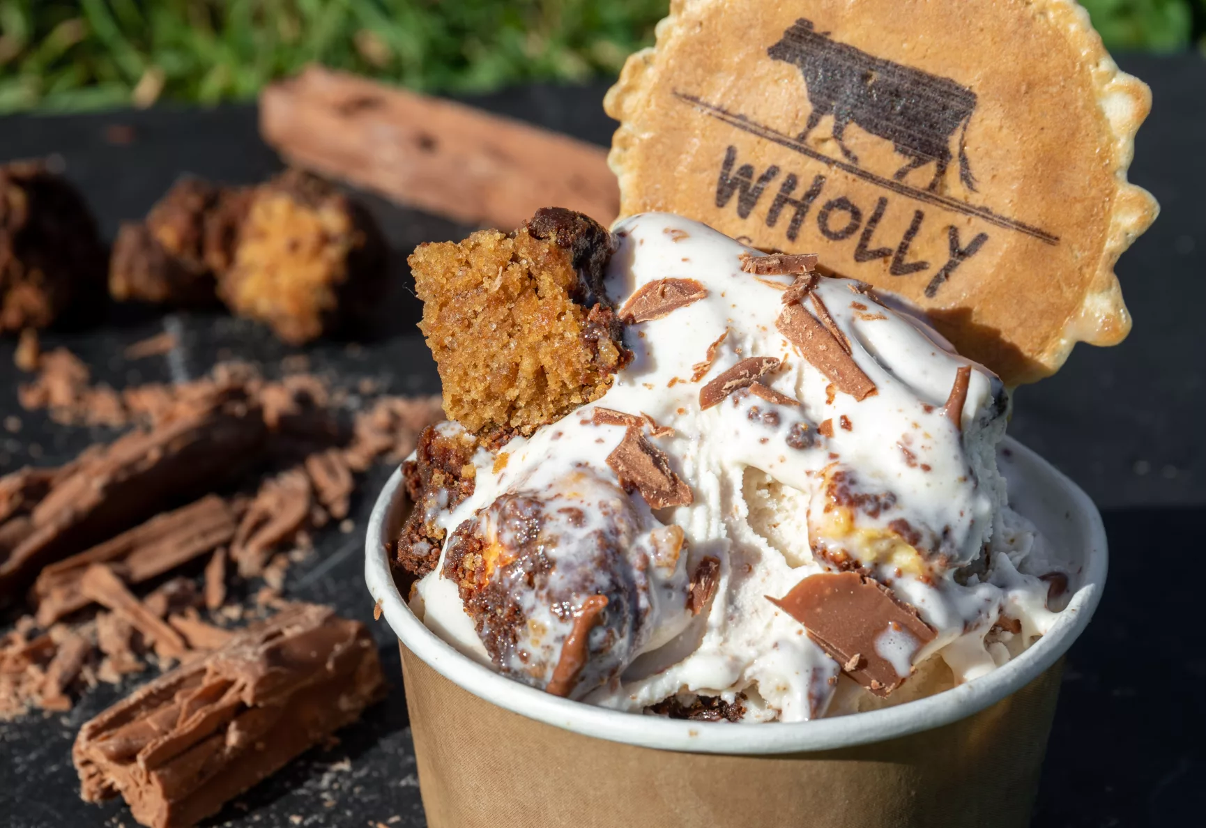 Chocolate brownie topped ice cream with a Wholly branded wafer