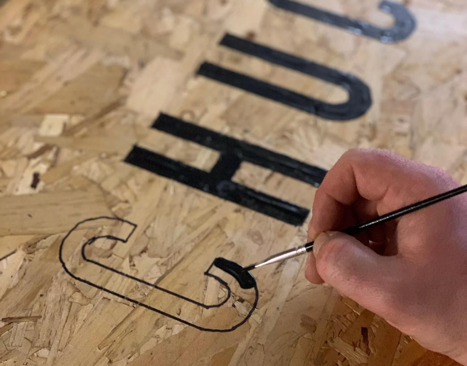 The Chuck sign in the process of being hand-painted
