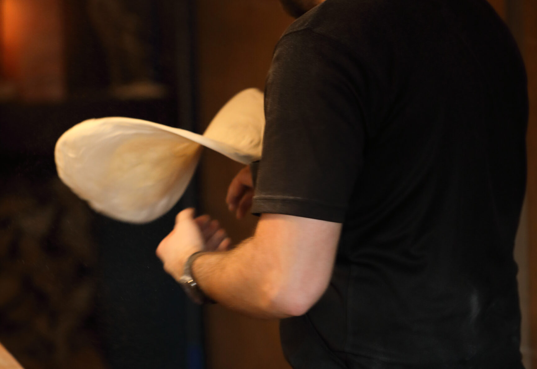 Jake tossing pizza dough in the Bella Mia Pizza open kitchen.