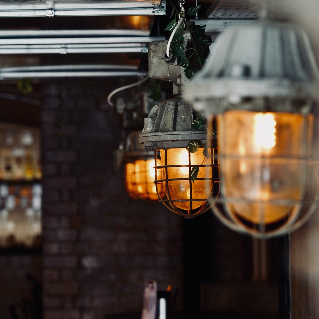 Industrial lanterns hanging down from the ceiling in Chuck Burger Bar.