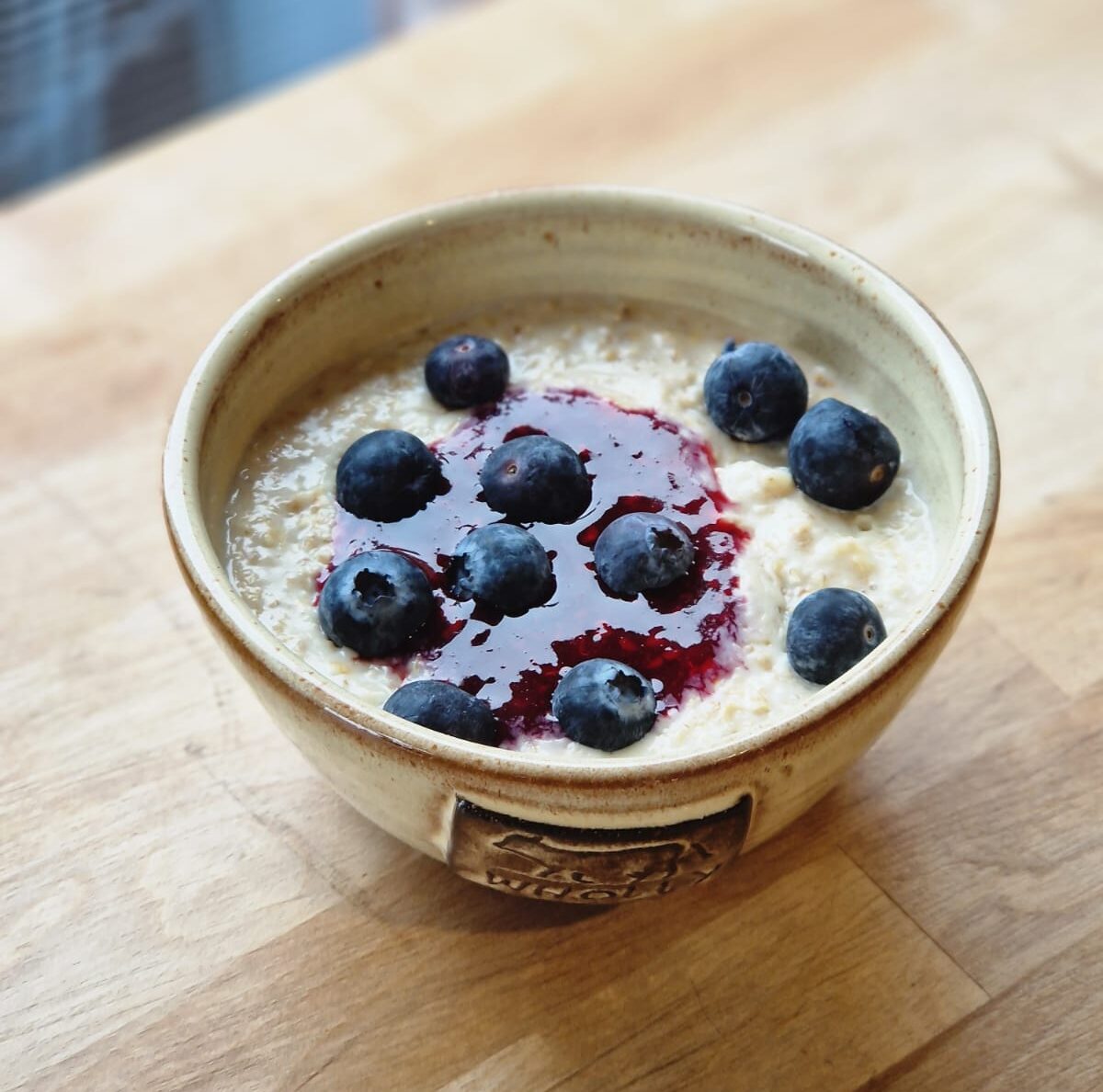 Wholly's porridge with fresh blueberries on top.