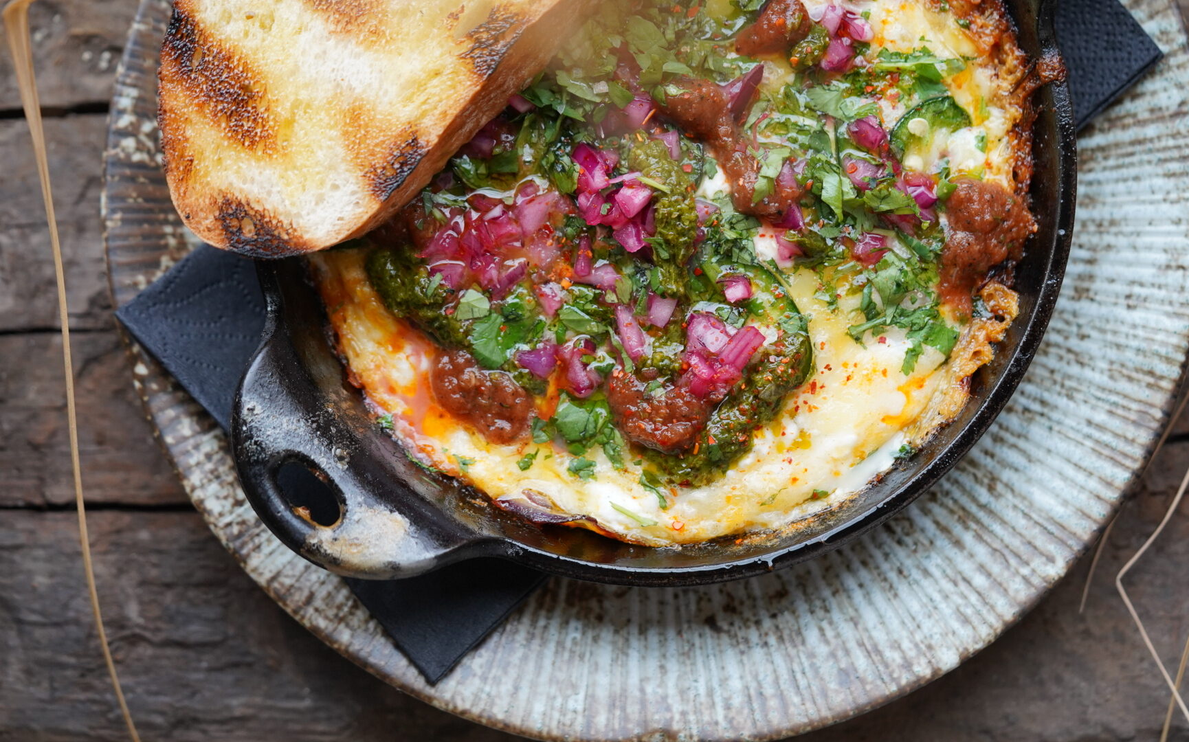 Crumbled chorizo, scrambled eggs, semi dried tomatoes, onion, salsa rojo, chimmichurri, queso fresco cheese, toast.
