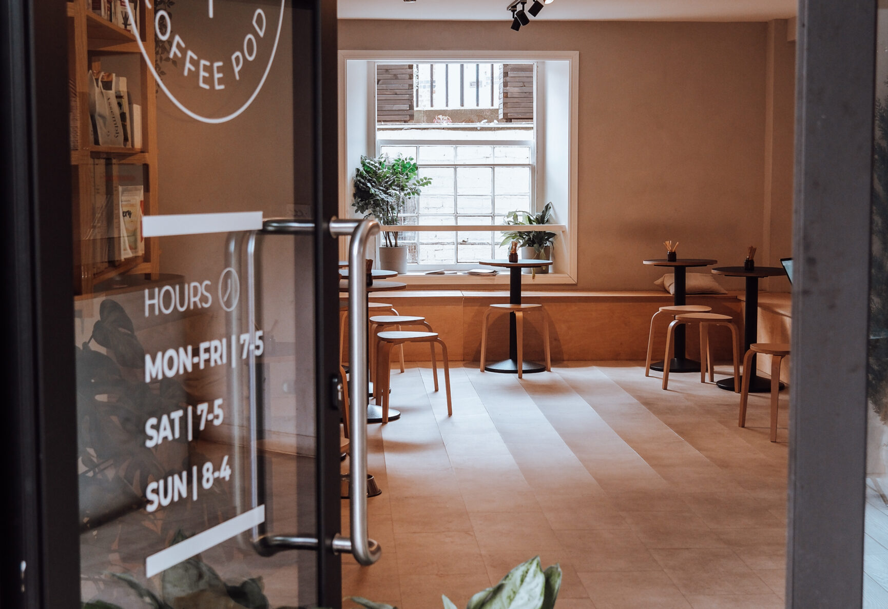 Looking through the open door, with plants propping the door open.