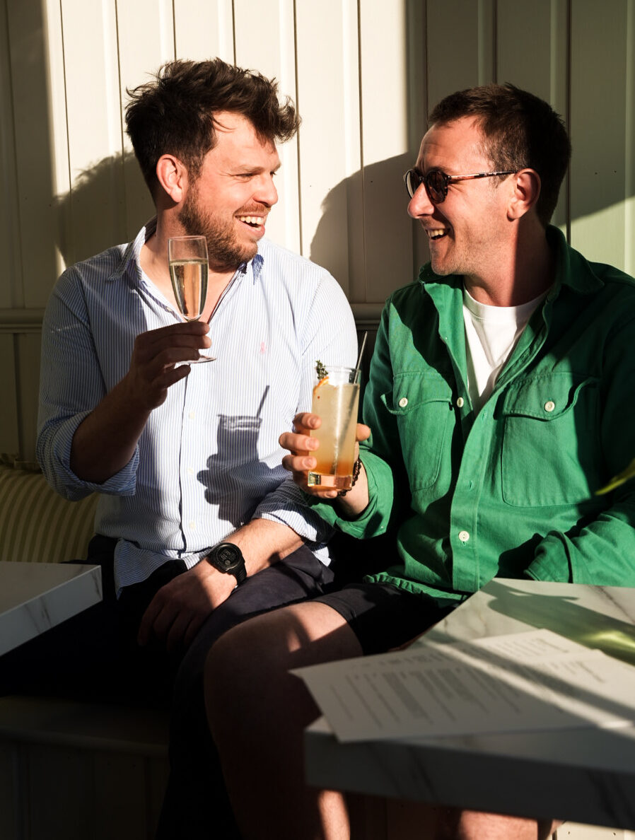 Sam and Toby sitting in the sunshine at Roots + Seeds Gloucester.