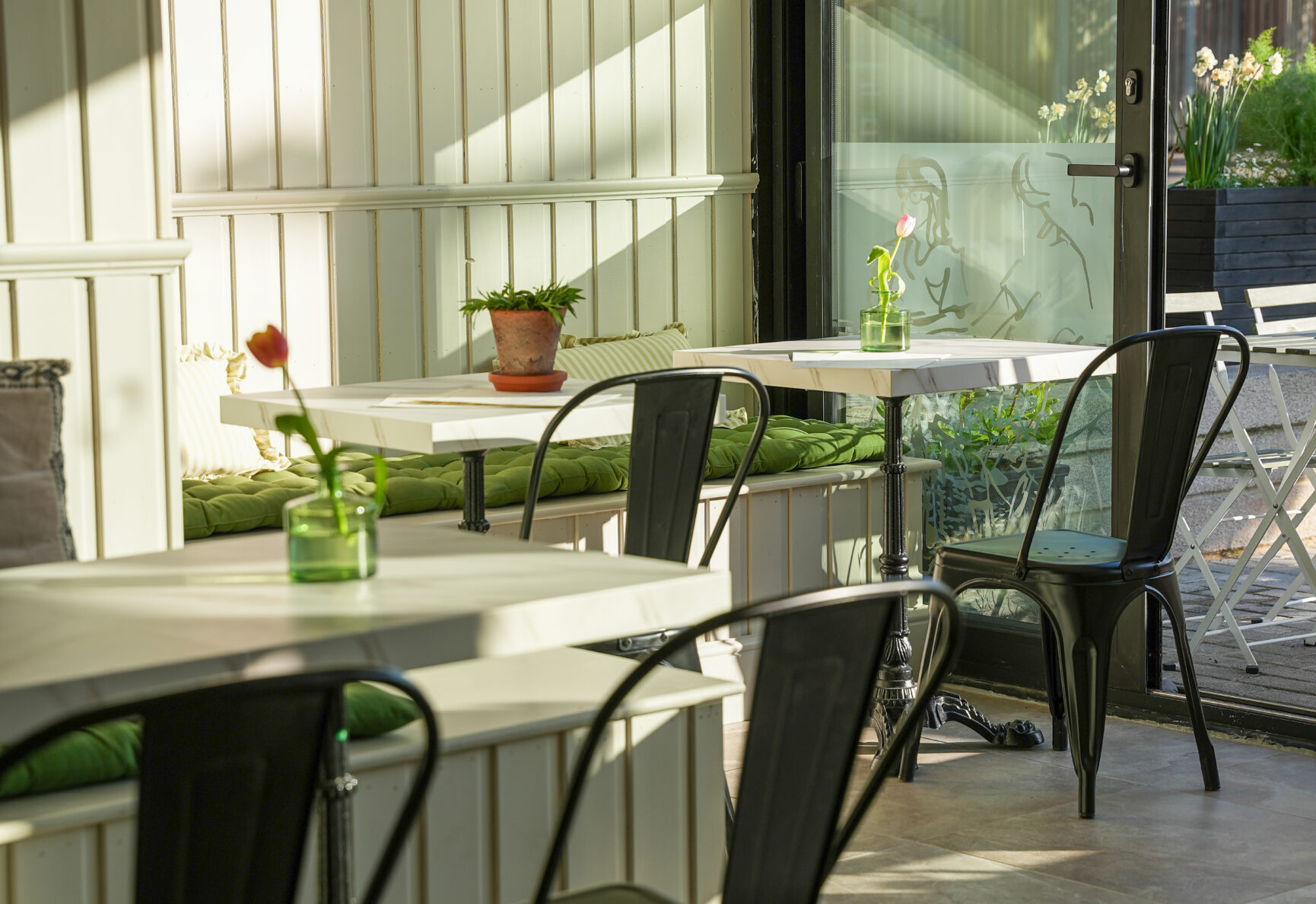 Morning sunlight shining into Roots + Seeds front interior seating area.