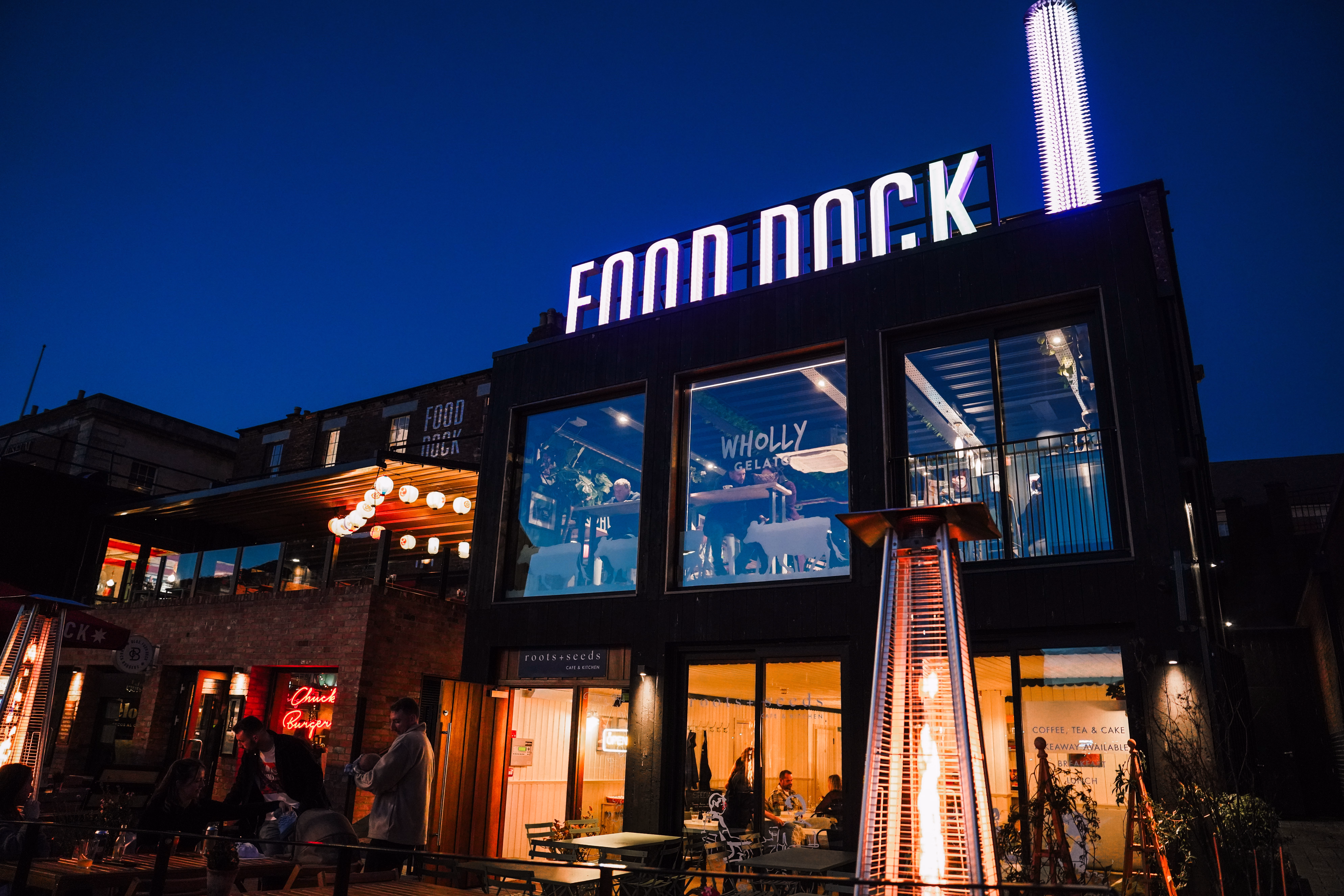 Looking at the Food Dock site at dusk with a blue sky.